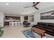 Spacious open-concept living room with a ceiling fan and a dining area and view of the kitchen at 14269 W El Cortez Pl, Surprise, AZ 85387