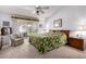 Bright bedroom with sliding glass doors to backyard, ceiling fan, and sitting area at 15395 W Pinchot Ct, Goodyear, AZ 85395