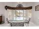 Bright dining area with large windows, glass table, and comfortable seating at 15395 W Pinchot Ct, Goodyear, AZ 85395