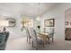 Inviting dining room featuring a glass top table, floral chairs, and bright natural light at 15395 W Pinchot Ct, Goodyear, AZ 85395