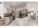 Spacious kitchen featuring white cabinets, granite countertops, and stainless steel appliances at 15395 W Pinchot Ct, Goodyear, AZ 85395