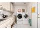 Laundry room featuring white washer and dryer, white cabinets and a stainless steel sink at 15395 W Pinchot Ct, Goodyear, AZ 85395