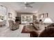 Comfortable living room with tiled floors, a plush sofa, and access to the backyard at 15395 W Pinchot Ct, Goodyear, AZ 85395