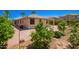 Backyard featuring a patio and desert landscape with trees and plants at 15471 W Post Cir, Surprise, AZ 85374