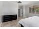 Bedroom with a large window, neutral walls, and a dark wood dresser at 15471 W Post Cir, Surprise, AZ 85374