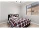 Neutral bedroom with a bed, bedside stool, and a window with blinds at 15471 W Post Cir, Surprise, AZ 85374
