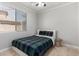 Neutral bedroom with a bed, bedside stool, and a window with blinds at 15471 W Post Cir, Surprise, AZ 85374