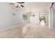 Open-concept living area featuring tile floors, modern lighting, and backyard views at 15471 W Post Cir, Surprise, AZ 85374