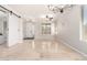 Bright living room with tile floors, a ceiling fan, and a sliding barn door at 15471 W Post Cir, Surprise, AZ 85374