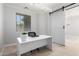 Bright office with a desk, chair, large window, modern lighting and barn door at 15471 W Post Cir, Surprise, AZ 85374
