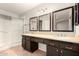Bathroom featuring a large vanity with double sinks, mirrors and a glass enclosed shower at 16638 N 46Th Ln, Glendale, AZ 85306
