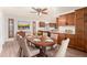 Charming dining room with a wood table set for six, complemented by wood cabinetry and granite countertops at 16638 N 46Th Ln, Glendale, AZ 85306