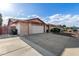 Lovely home with a spacious driveway, a two-car garage, and a tidy front yard at 16638 N 46Th Ln, Glendale, AZ 85306