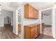 Hallway with wood-look flooring, storage cabinets, and views into other rooms at 16638 N 46Th Ln, Glendale, AZ 85306