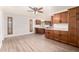 Well-lit kitchen boasting wood cabinetry, granite countertops, stainless steel appliances, and sleek wood flooring at 16638 N 46Th Ln, Glendale, AZ 85306