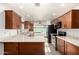 Bright kitchen showcasing granite countertops, wood cabinetry, and modern appliances at 16638 N 46Th Ln, Glendale, AZ 85306