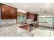 Spacious kitchen featuring granite countertops, wood cabinets, and stainless steel appliances at 16638 N 46Th Ln, Glendale, AZ 85306