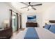 Serene main bedroom featuring a sleek ceiling fan, sliding glass doors, and modern decor at 16638 N 46Th Ln, Glendale, AZ 85306