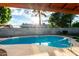Backyard pool and outdoor living space, with blue water and sunny skies at 16638 N 46Th Ln, Glendale, AZ 85306