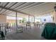 Relaxing back porch with multiple chairs, tables, and string lights at 17200 W Bell Rd # 840, Surprise, AZ 85374