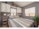 Relaxing bedroom features a large bed, overhead cabinets, and multiple windows at 17200 W Bell Rd # 840, Surprise, AZ 85374
