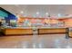 Spacious buffet area with orange walls, serving counters, and a tiled floor at 17200 W Bell Rd # 840, Surprise, AZ 85374