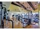Bright gym with modern exercise equipment, wood floors, and vaulted ceiling at 17200 W Bell Rd # 840, Surprise, AZ 85374