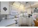 Bright kitchen features white appliances, countertops, cabinets, and an overhead fan at 17200 W Bell Rd # 840, Surprise, AZ 85374