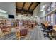 Inviting library space with bookshelves, comfortable seating, and a large television at 17200 W Bell Rd # 840, Surprise, AZ 85374