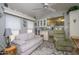 Cozy living room area features a comfortable couch, arm chair, and overhead fan at 17200 W Bell Rd # 840, Surprise, AZ 85374