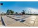 Outdoor shuffleboard courts with clearly marked lanes and palm trees at 17200 W Bell Rd # 840, Surprise, AZ 85374