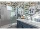 Bathroom featuring modern vanity, floral wallpaper and walk-in shower at 17710 W Guthrie St, Surprise, AZ 85388