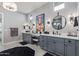 Bathroom with dual vanities, modern fixtures, a decorative mirror, and ample countertop space at 17710 W Guthrie St, Surprise, AZ 85388