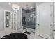 Stylish bathroom featuring a glass-enclosed shower with decorative tile and modern lighting fixtures at 17710 W Guthrie St, Surprise, AZ 85388