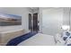 Bedroom featuring a wall-mounted TV, closet, and view into ensuite bathroom at 17710 W Guthrie St, Surprise, AZ 85388
