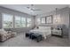 Serene bedroom with natural light, plush carpeting, neutral tones, a ceiling fan, and stylish furnishings at 17710 W Guthrie St, Surprise, AZ 85388