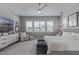 Bright bedroom with soft carpet, neutral tones, plantation shutters, a ceiling fan, and modern decor at 17710 W Guthrie St, Surprise, AZ 85388