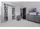Bedroom featuring closet, dresser, television, and view into ensuite bathroom at 17710 W Guthrie St, Surprise, AZ 85388