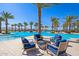 Community pool area featuring plenty of seating around a fire pit at 17710 W Guthrie St, Surprise, AZ 85388
