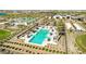 Aerial shot of the resort-style community pool featuring a unique design, surrounded by lush landscaping and seating areas at 17710 W Guthrie St, Surprise, AZ 85388