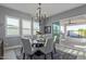 Bright dining area with chandelier, modern table set, and sliding glass door to patio at 17710 W Guthrie St, Surprise, AZ 85388