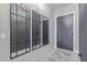 Stylish entryway with modern mirrors, a decorative rug, and a sleek front door at 17710 W Guthrie St, Surprise, AZ 85388