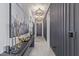 Sophisticated entryway featuring modern light fixtures, a console table with art, and stylish decor at 17710 W Guthrie St, Surprise, AZ 85388