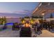 Inviting outdoor patio with a modern fire pit, comfortable seating, and a tranquil atmosphere for relaxation and entertaining at 17710 W Guthrie St, Surprise, AZ 85388