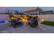 Inviting outdoor space featuring a cozy fire pit under a pergola with comfortable seating and manicured landscaping at 17710 W Guthrie St, Surprise, AZ 85388