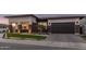 Inviting front exterior showcasing a manicured lawn, stone details, and a spacious two-car garage at 17710 W Guthrie St, Surprise, AZ 85388