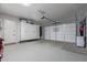 Spacious garage features epoxy floors, a large storage cabinet and garage door at 17710 W Guthrie St, Surprise, AZ 85388