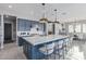 Stunning kitchen features a large island with marble countertops, navy blue cabinets, and modern pendant lighting at 17710 W Guthrie St, Surprise, AZ 85388