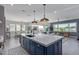 Open-concept kitchen with a large island, marble countertops, and stainless steel appliances, perfect for entertaining at 17710 W Guthrie St, Surprise, AZ 85388