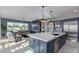 Gourmet kitchen with oversized island, stainless steel appliances, and adjacent living area at 17710 W Guthrie St, Surprise, AZ 85388